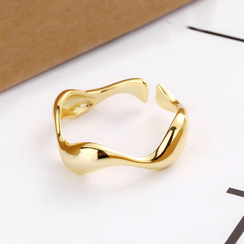 Wavy gold band worn stacked