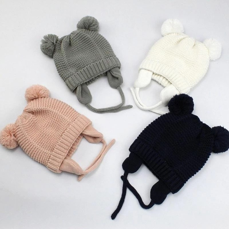 Kids double pom pom knit beanies in grey, navy, pink and cream with ear flaps
