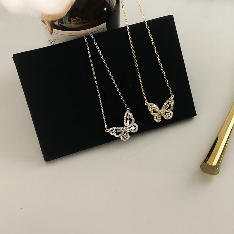 Butterfly pendant necklace worn layered