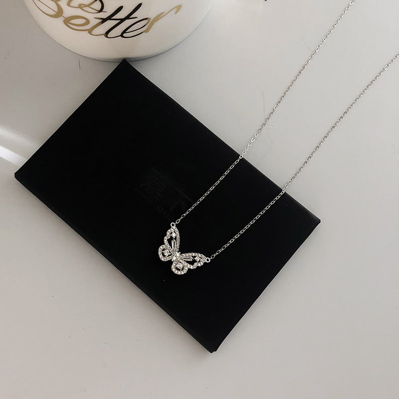 Crystal butterfly necklace laid flat