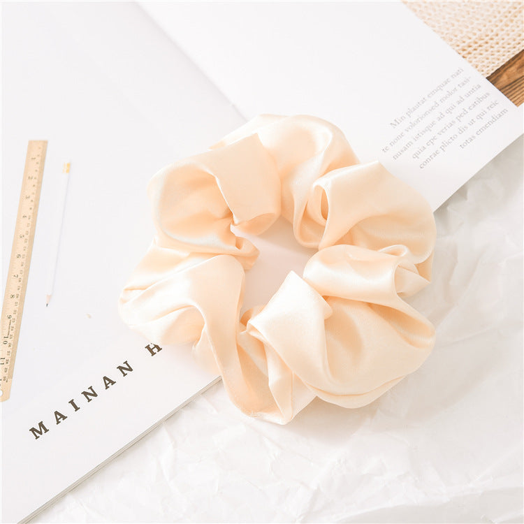 Satin scrunchies stacked in a pile