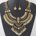 Oxidized coin necklace set on a display bust