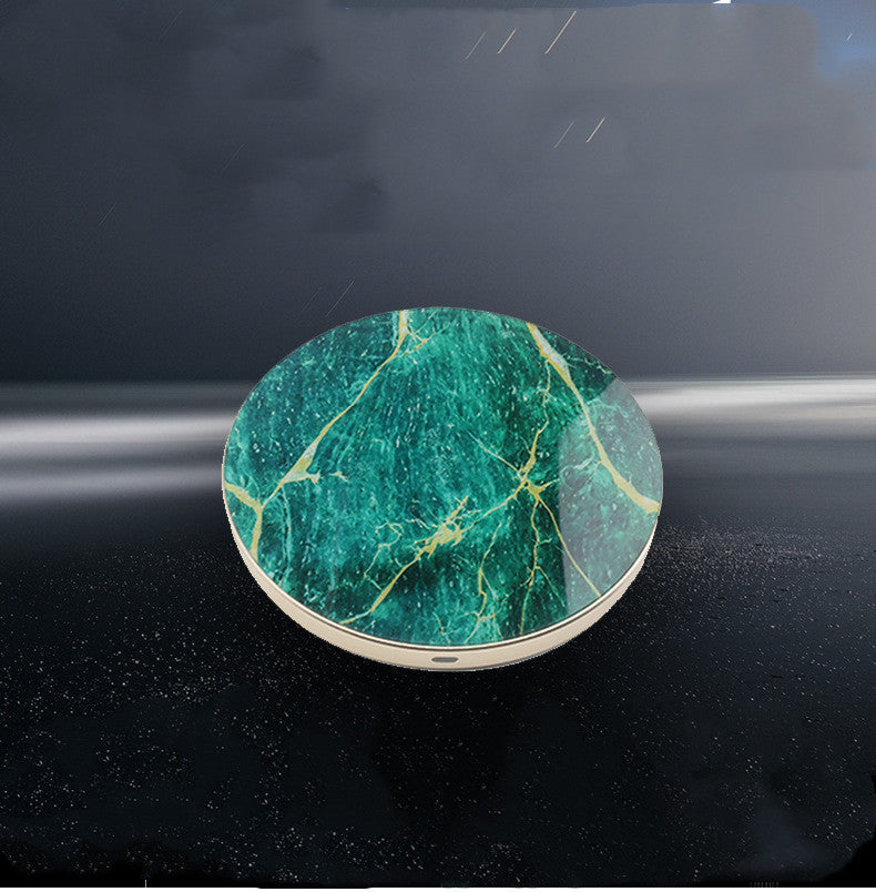 Green marble wireless charging pad on a dark surface