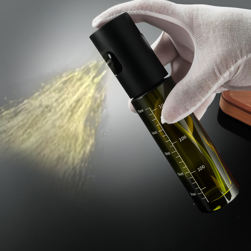 Empty olive oil spray bottle with funnel in the box
