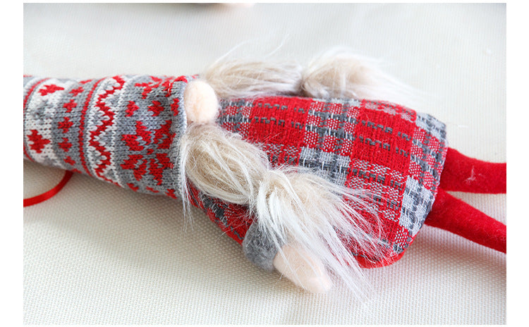 Three long leg Christmas plush ornaments sitting in a row