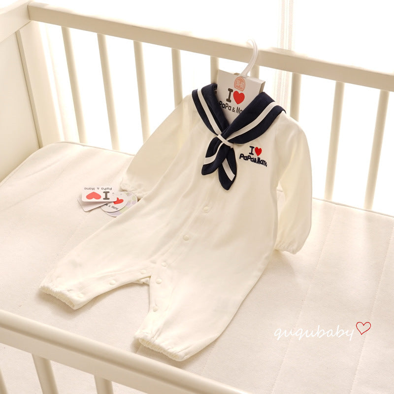 Sailor collar romper laid in a crib