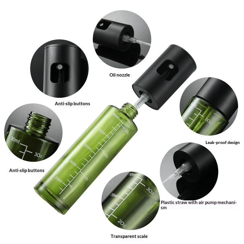 Olive oil sprayer on a dark counter beside a board