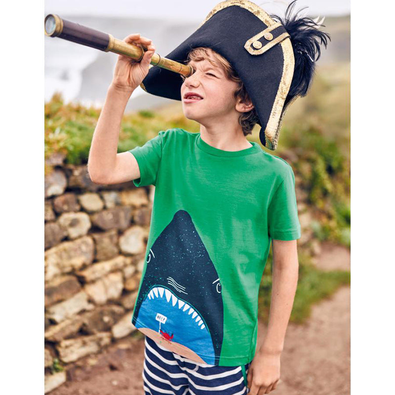 Child wearing the green shark print T-shirt