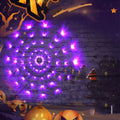 Purple LED Halloween spider web lights glowing on a dark wall