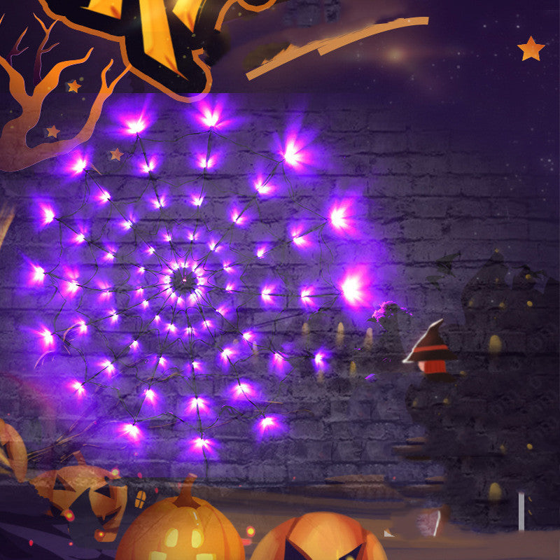 Purple LED Halloween spider web lights glowing on a dark wall