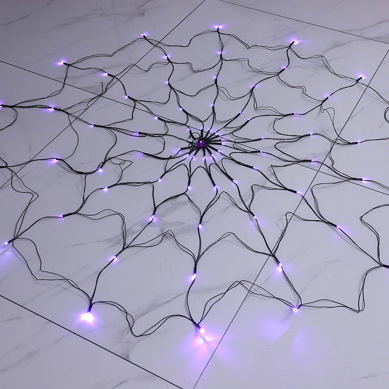LED spider web lights laid flat showing full 1.5 m web size with purple bulbs