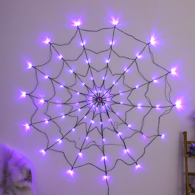 Purple LED spider web light glowing on a wall, about 1.5 m wide