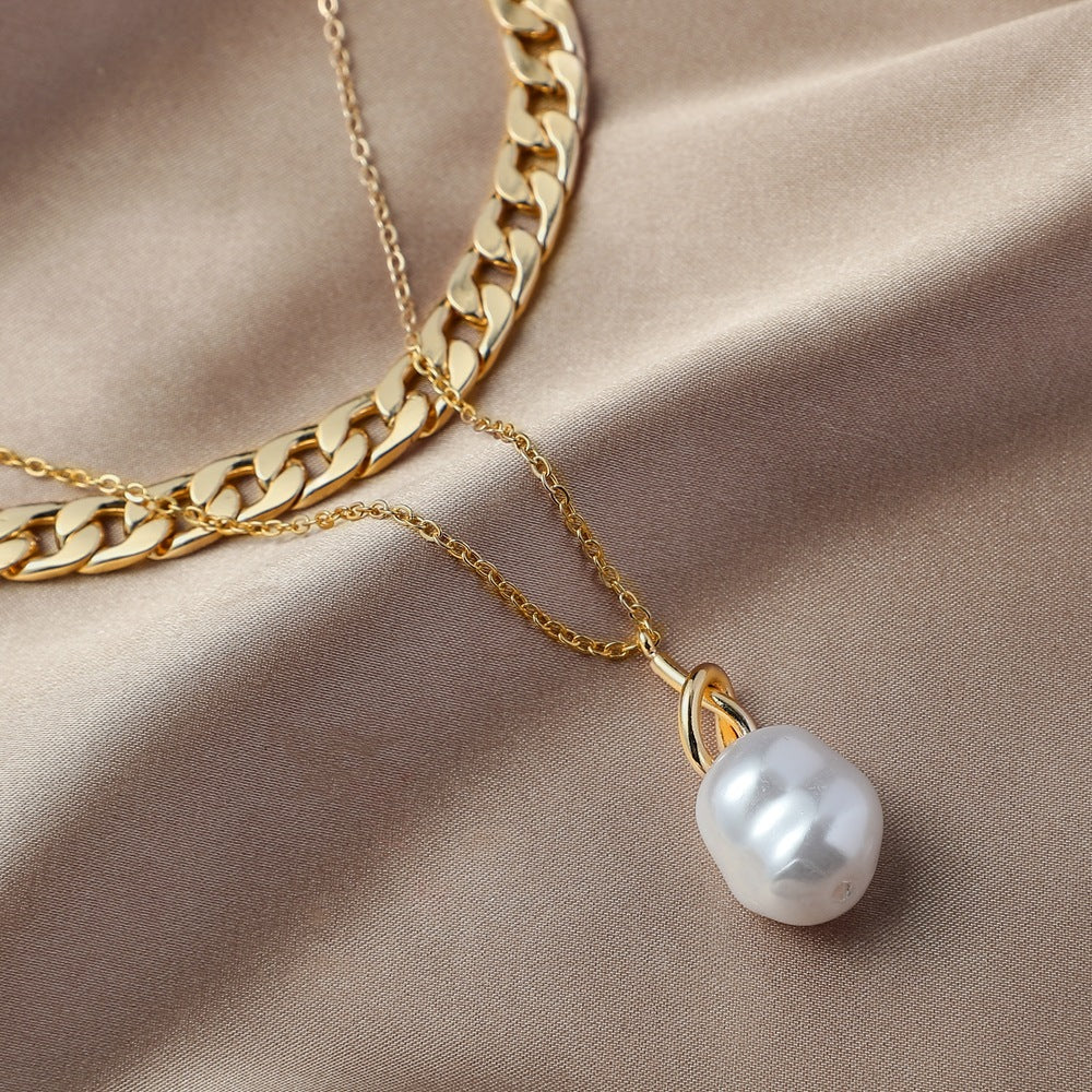 Baroque pearl pendant necklace laid flat