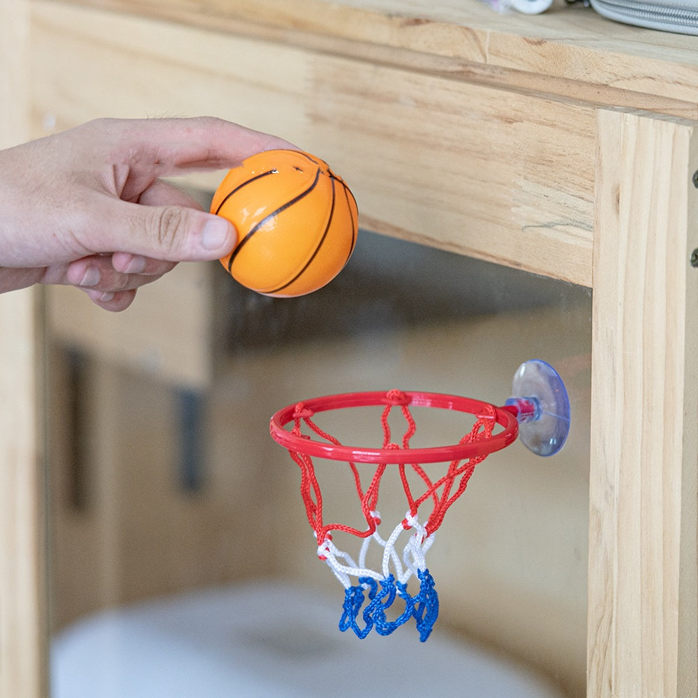 Hand shooting the mini ball into the hoop