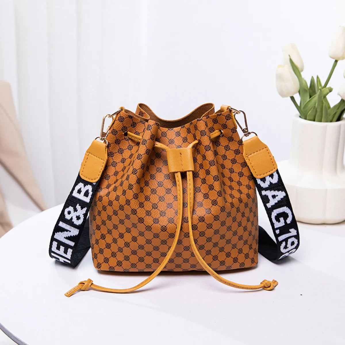 Women's beige PU bucket crossbody bag with adjustable strap