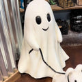 Halloween ghost walking a dog desktop ornament on a shelf