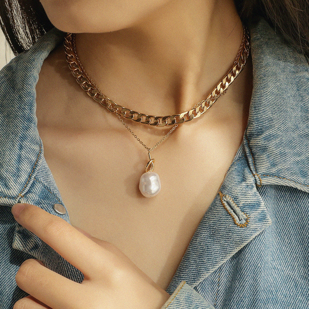 Baroque pearl necklace worn at collarbone