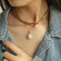 Baroque pearl necklace worn at collarbone