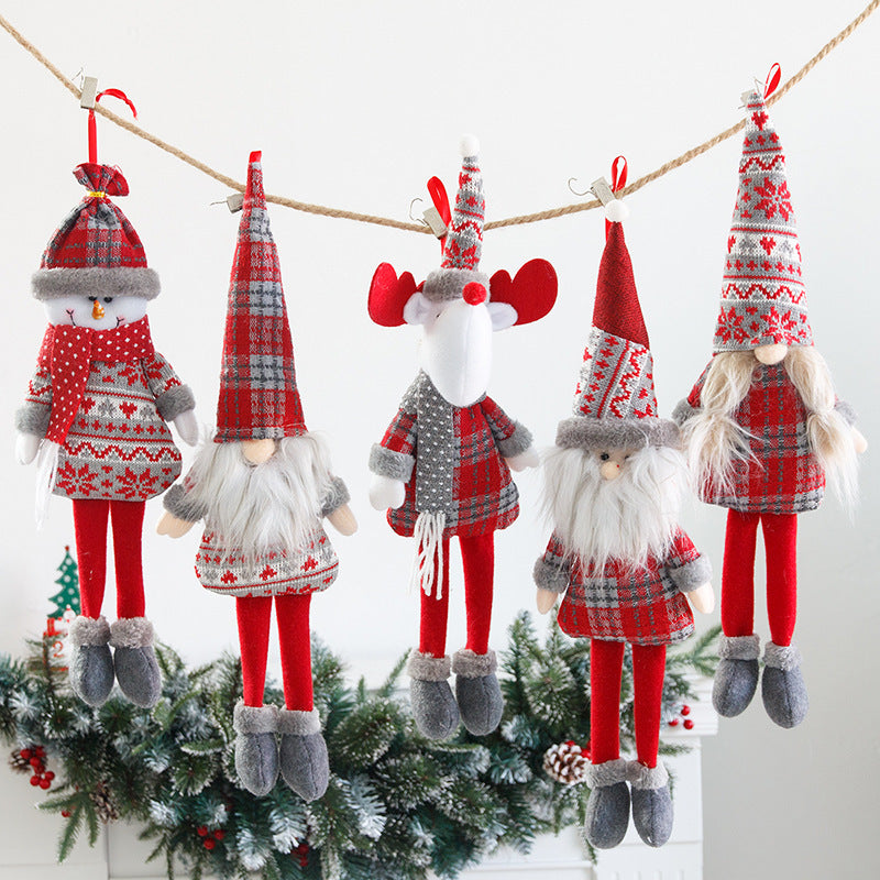 Christmas gnome plush ornament with long dangly legs hanging from a shelf