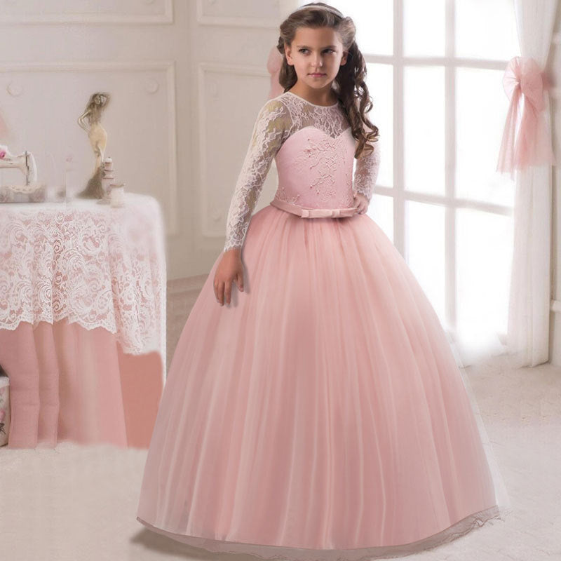 Girl wearing a pink lace flower girl dress