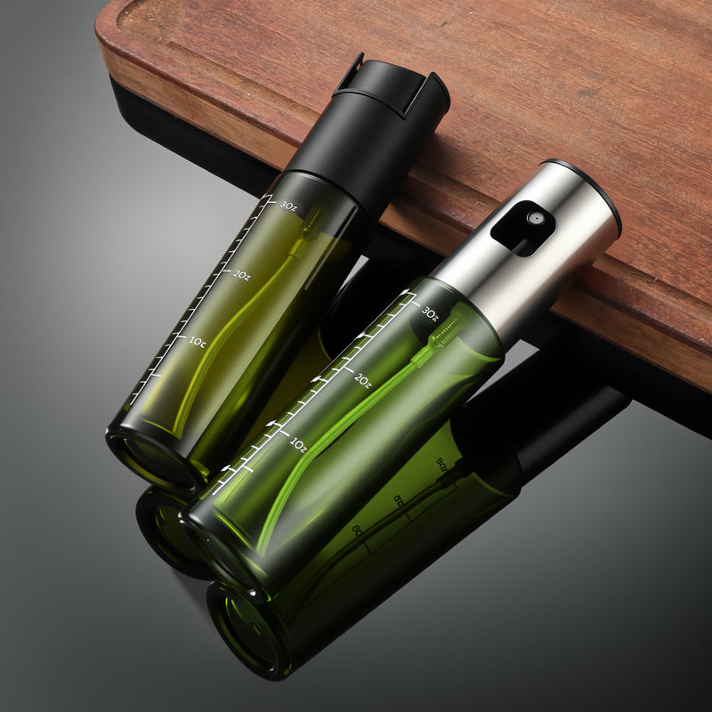 Green glass olive oil spray bottles in black and silver