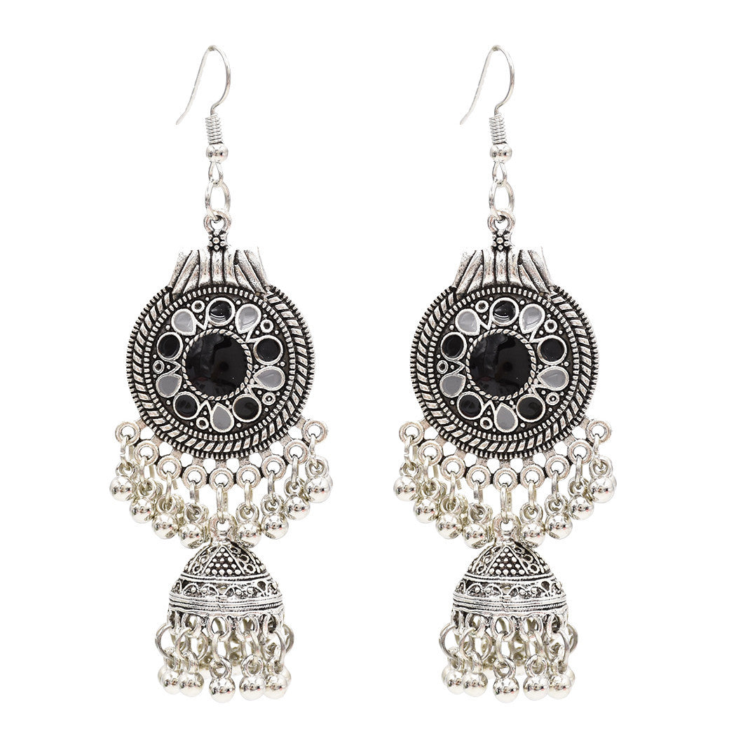 Pair of oxidized jhumka earrings laid flat