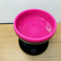 Portable USB electric makeup brush cleaner spinning a foundation brush
